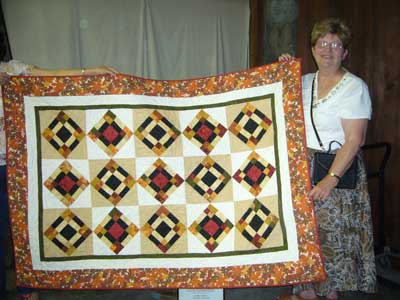 Pam Beebe presents quilt to The Living Room